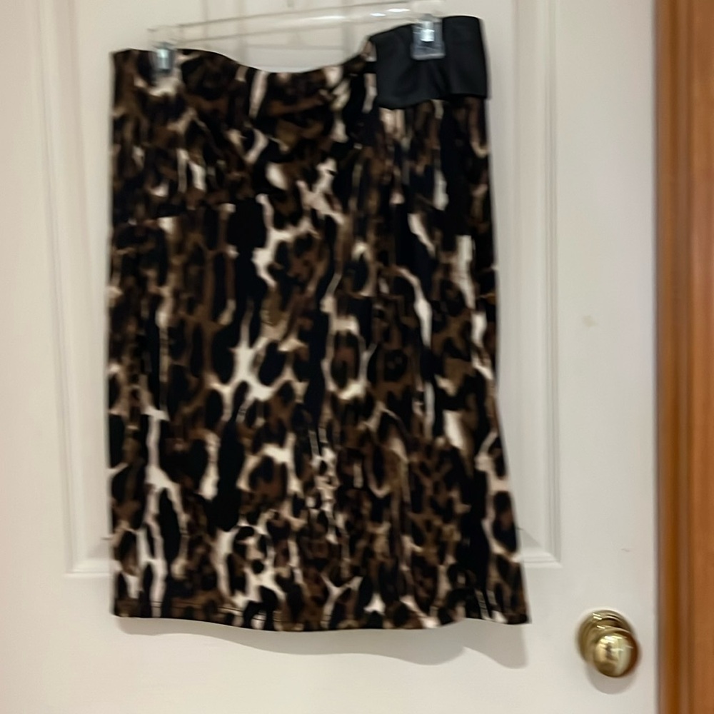 Very unique knee length skirt. Faux leather on one side. Elastic waist